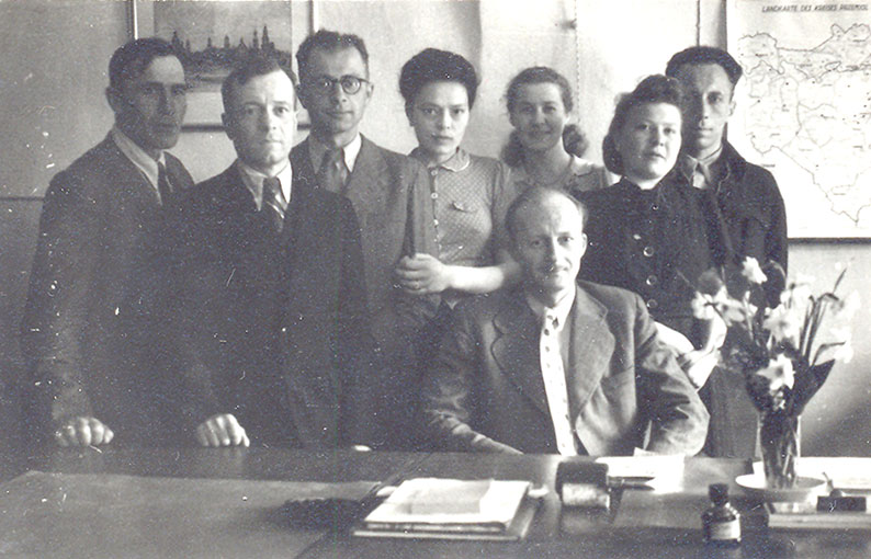 As a manager of a fruit and vegetable collection point in Przemyśl (sitting), his later wife Maria fourth from the left, 1942–1945